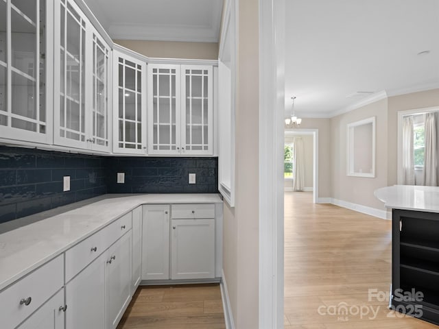 709 Cavesson Way, Monroe, NC 28110 - kitchen featuring backsplash, ornamental molding, wine cooler, healthy amount of natural light, and light wood finished floors