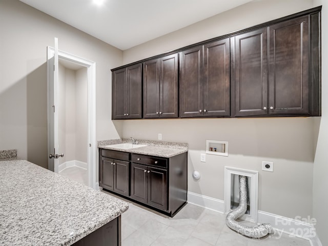 709 Cavesson Way, Monroe, NC 28110 - laundry area featuring cabinet space, hookup for an electric dryer, hookup for a washing machine, gas dryer hookup, and light tile patterned floors