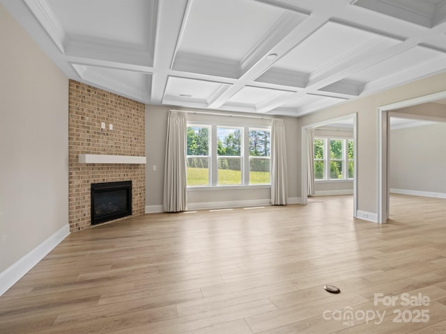 709 Cavesson Way, Monroe, NC 28110 - unfurnished living room with a fireplace, light wood-type flooring, coffered ceiling, beamed ceiling, and crown molding