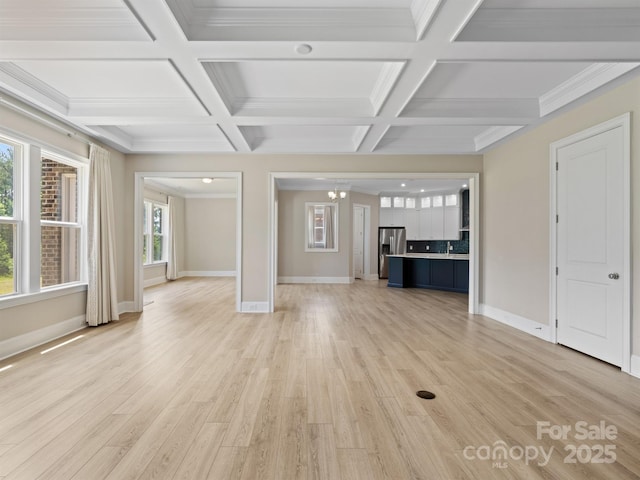 709 Cavesson Way, Monroe, NC 28110 - unfurnished living room with coffered ceiling, a chandelier, light wood-type flooring, and beam ceiling