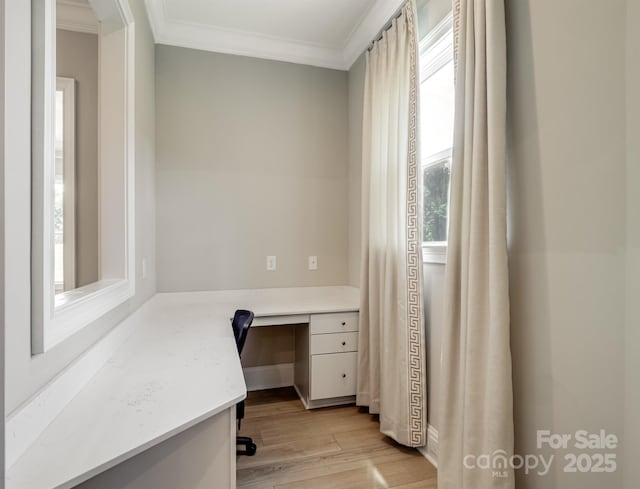 709 Cavesson Way, Monroe, NC 28110 - unfurnished office with built in desk, crown molding, and light wood-type flooring