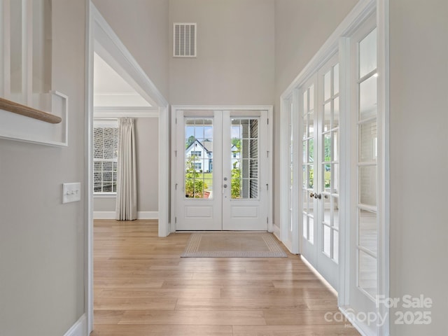 709 Cavesson Way, Monroe, NC 28110 - entrance foyer featuring french doors, light wood finished floors, and a towering ceiling
