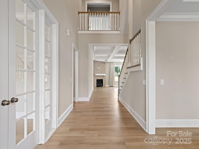 709 Cavesson Way, Monroe, NC 28110 - entryway with wood finished floors, stairway, a fireplace, and crown molding
