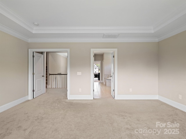 709 Cavesson Way, Monroe, NC 28110 - unfurnished bedroom featuring ornamental molding, a raised ceiling, and light colored carpet
