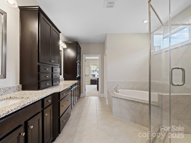 709 Cavesson Way, Monroe, NC 28110 - full bathroom with tile patterned floors, double vanity, a bath, and a stall shower