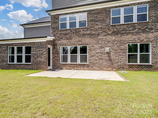 709 Cavesson Way, Monroe, NC 28110 - rear view of house featuring brick siding, a patio, and a yard