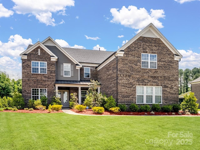 709 Cavesson Way, Monroe, NC 28110 - view of front facade featuring brick siding, a front lawn, a standing seam roof, and a metal roof