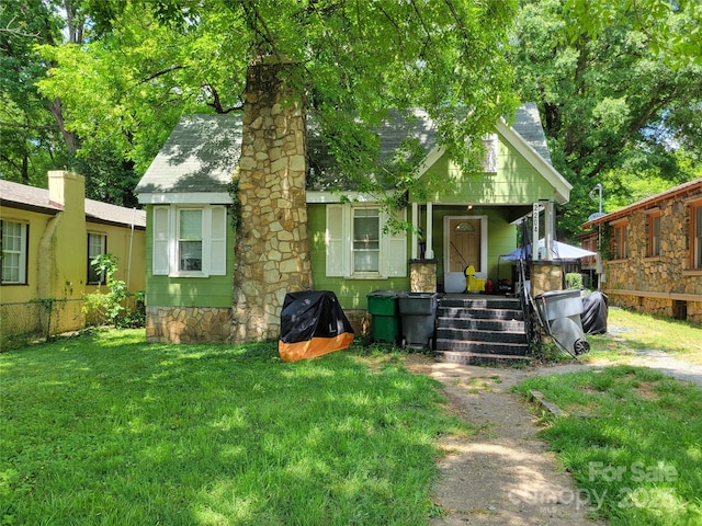 view of front of house with a chimney and a porch