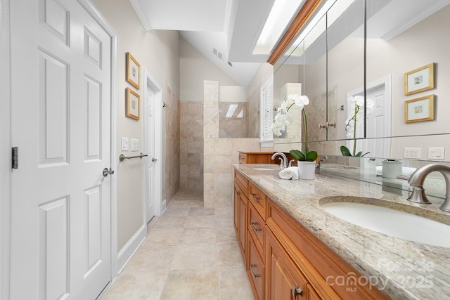 bathroom featuring a sink, tile patterned flooring, walk in shower, and visible vents