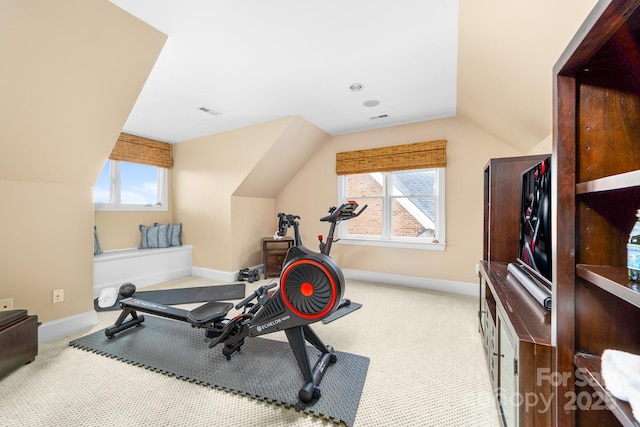 workout room with lofted ceiling, baseboards, and carpet