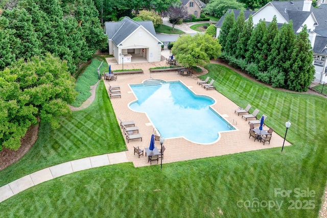 community pool featuring a yard and a patio area