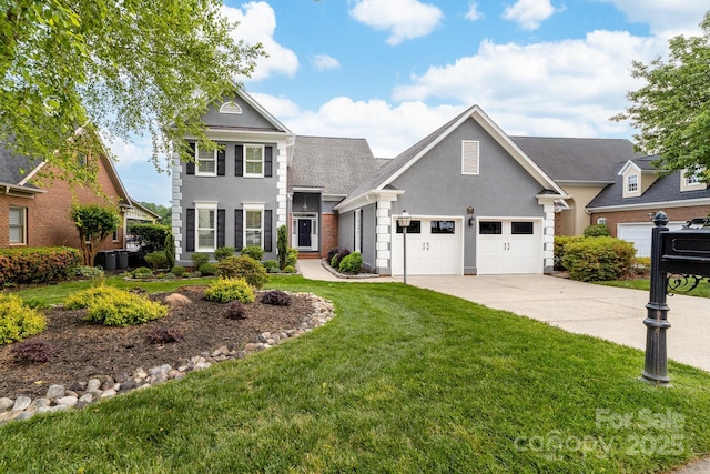 traditional-style house featuring a front lawn, driveway, stucco siding, and a garage