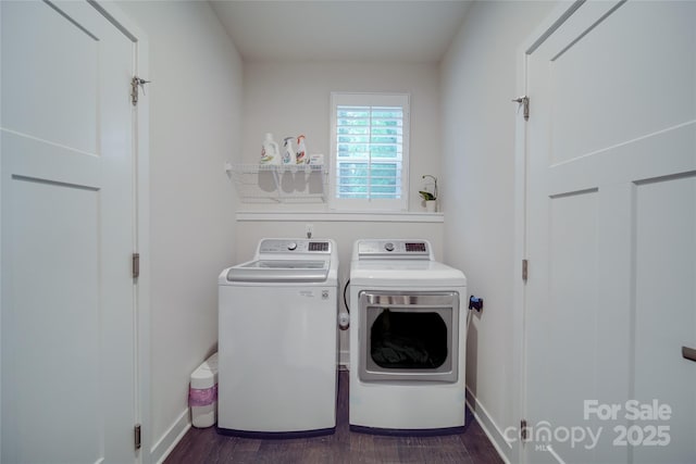 laundry room with washer and clothes dryer, dark wood-type flooring, and baseboards