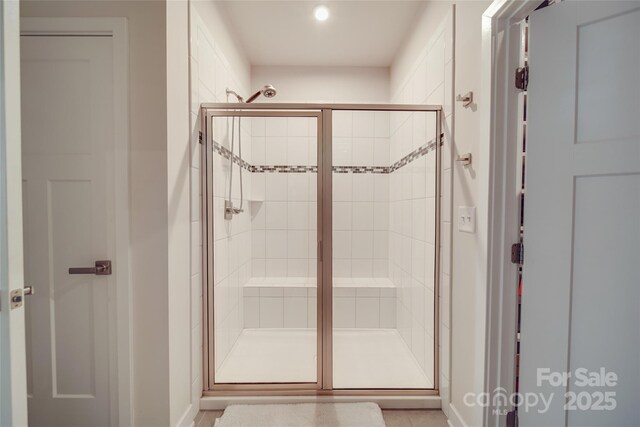 bathroom with a stall shower, recessed lighting, and baseboards