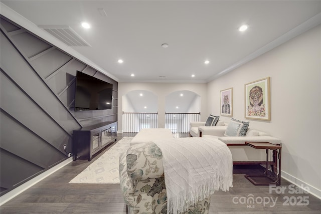 bedroom with dark wood-style flooring, baseboards, ornamental molding, and recessed lighting