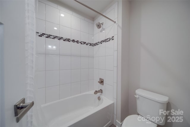 full bathroom featuring shower / bath combination with curtain and toilet