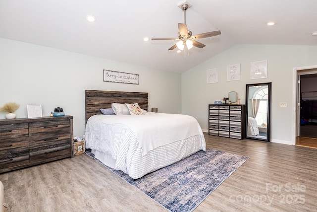 bedroom featuring lofted ceiling, baseboards, a ceiling fan, and wood finished floors