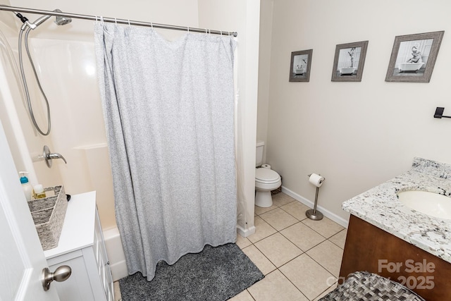 full bath featuring vanity, toilet, baseboards, and tile patterned flooring