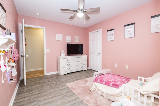 bedroom featuring baseboards, ceiling fan, and wood finished floors