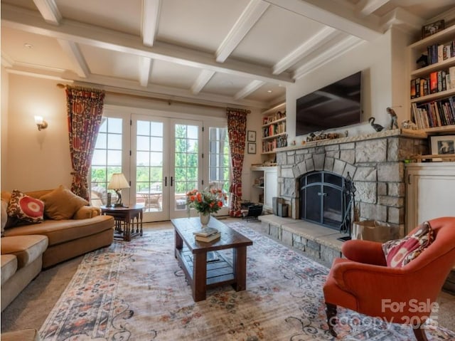 living area with french doors, a fireplace, beam ceiling, and coffered ceiling