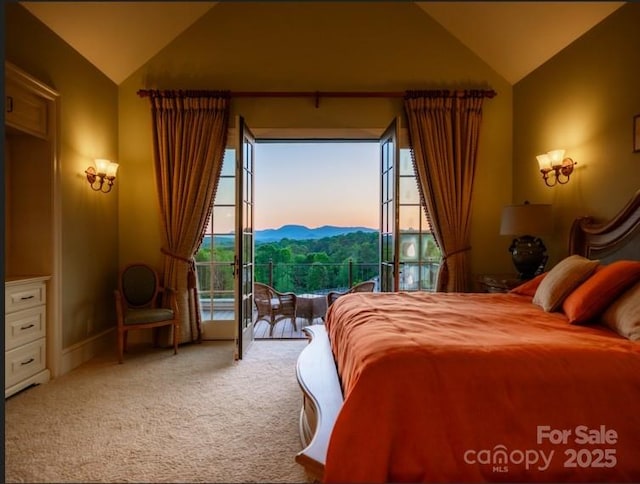 carpeted bedroom featuring access to outside, a mountain view, and vaulted ceiling