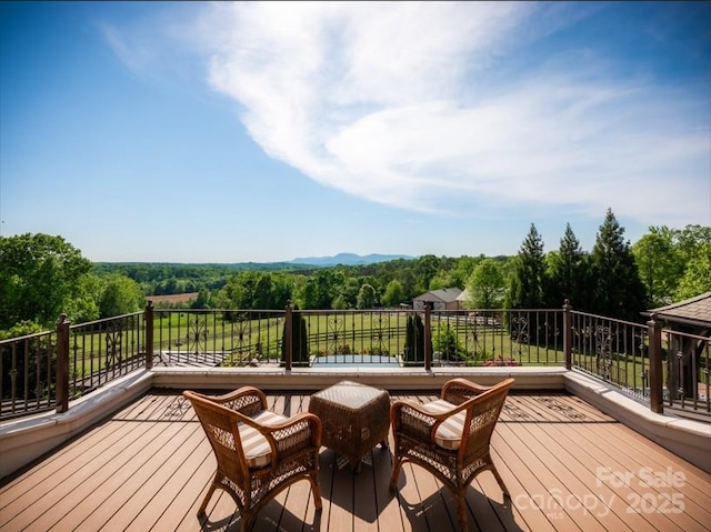 wooden deck with a view of trees