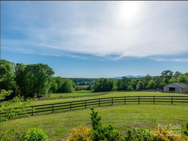 view of yard featuring fence and a rural view