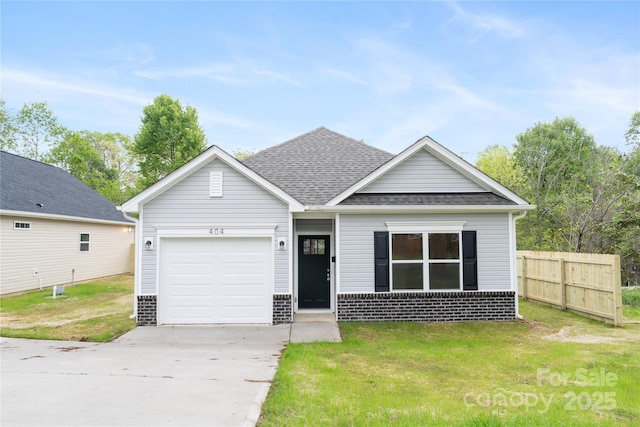 401 Groves St, Lowell, NC 28098 - view of front facade with concrete driveway, an attached garage, brick siding, and a shingled roof