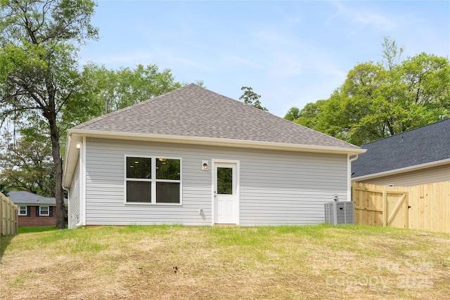 401 Groves St, Lowell, NC 28098 - back of property with a shingled roof and central AC unit