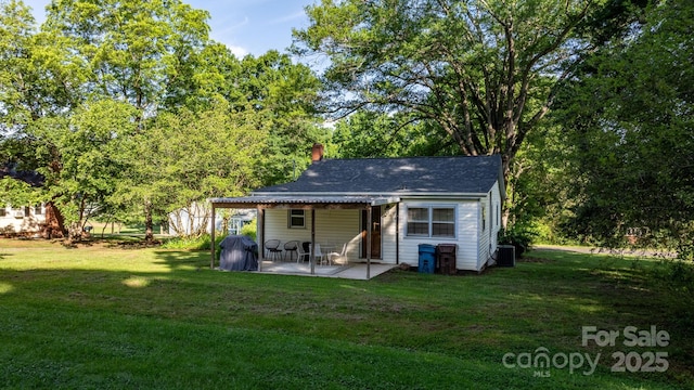 116 Barnes Ln, Stony Point, NC 28678 - back of property featuring a patio, central AC, a yard, and a chimney