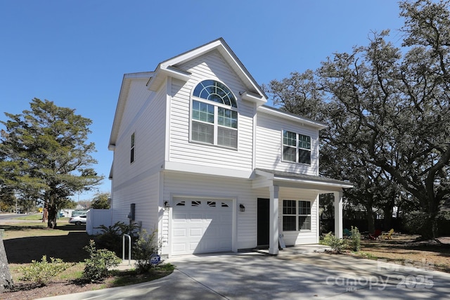 traditional-style home featuring a garage and driveway