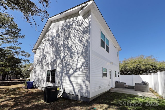 rear view of house with a patio, fence, central air condition unit, and an outdoor living space