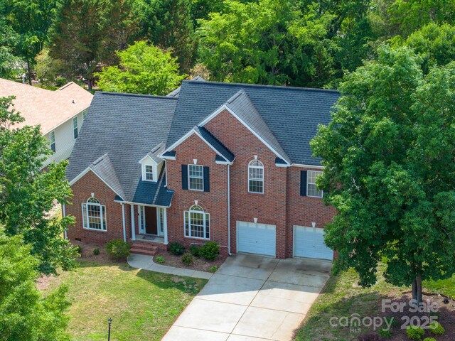1465 Porters Ct, Concord, NC 28025 - view of front of property featuring driveway, an attached garage, brick siding, a front yard, and a shingled roof