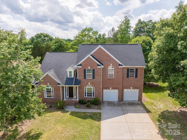 1465 Porters Ct, Concord, NC 28025 - view of front of house with driveway, a garage, brick siding, and a front lawn