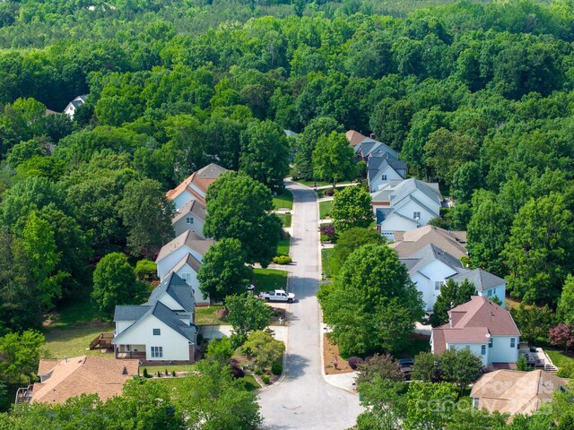 1465 Porters Ct, Concord, NC 28025 - aerial perspective of suburban area with a heavily wooded area