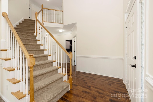 1465 Porters Ct, Concord, NC 28025 - stairs featuring wood finished floors, a wainscoted wall, ornamental molding, a towering ceiling, and baseboards