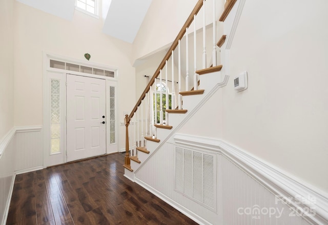 1465 Porters Ct, Concord, NC 28025 - entryway with a wainscoted wall, stairway, wood-type flooring, high vaulted ceiling, and a decorative wall