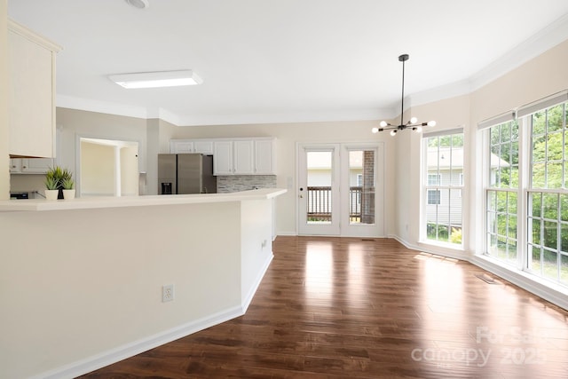 1465 Porters Ct, Concord, NC 28025 - kitchen featuring stainless steel fridge, dark wood-style floors, a chandelier, ornamental molding, and a peninsula