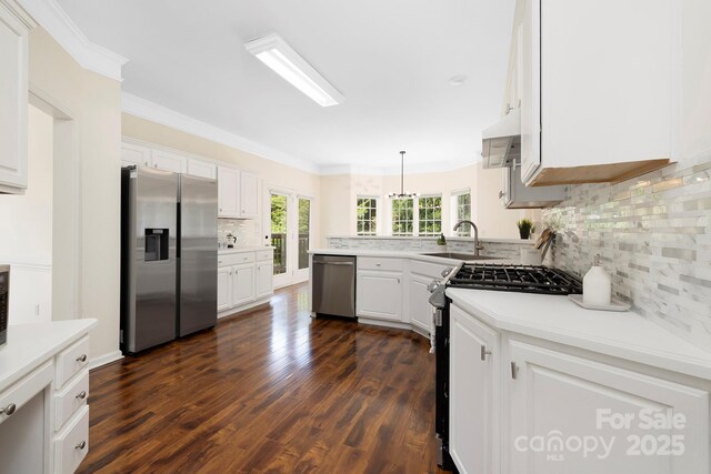 1465 Porters Ct, Concord, NC 28025 - kitchen featuring stainless steel appliances, a sink, tasteful backsplash, white cabinetry, and ornamental molding