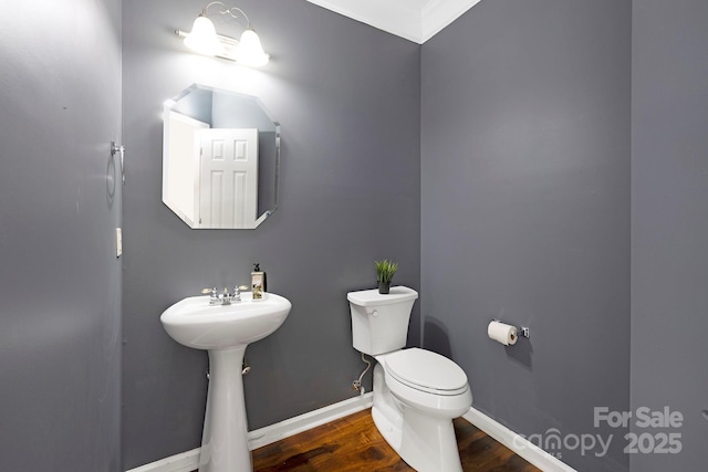 1465 Porters Ct, Concord, NC 28025 - half bathroom featuring toilet, wood finished floors, baseboards, a sink, and ornamental molding