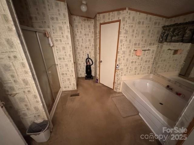 bathroom with a stall shower, crown molding, and a bath