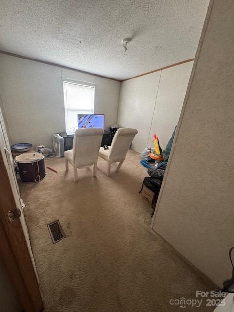 interior space with a textured ceiling and visible vents