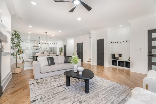 2224 Highland St, Charlotte, NC 28208 - living area with ceiling fan, stairway, recessed lighting, light wood-style flooring, and crown molding