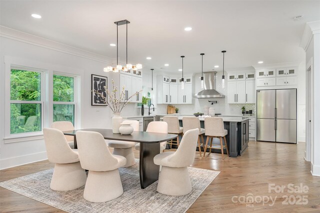 2224 Highland St, Charlotte, NC 28208 - dining space with baseboards, recessed lighting, ornamental molding, and light wood-style floors
