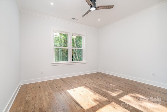 2224 Highland St, Charlotte, NC 28208 - spare room with crown molding, a ceiling fan, light wood-style floors, baseboards, and recessed lighting