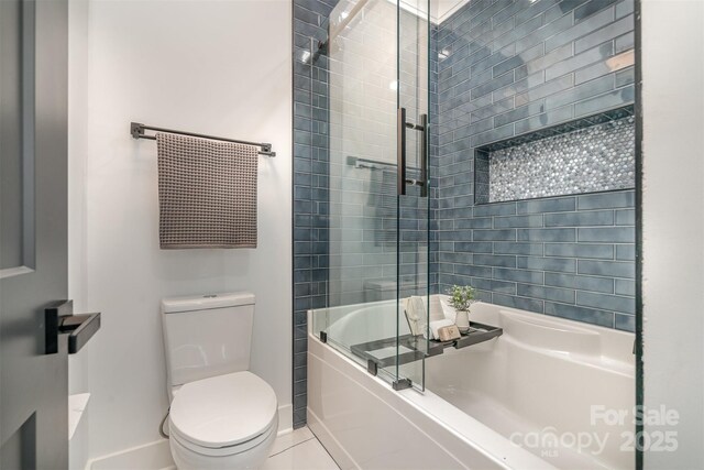 2224 Highland St, Charlotte, NC 28208 - bathroom featuring baseboards, shower / bath combination with glass door, and toilet