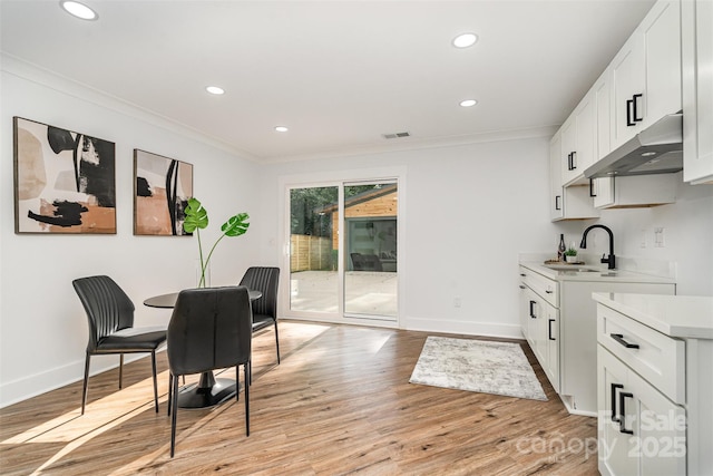 2224 Highland St, Charlotte, NC 28208 - dining room with ornamental molding, recessed lighting, light wood-style floors, and baseboards