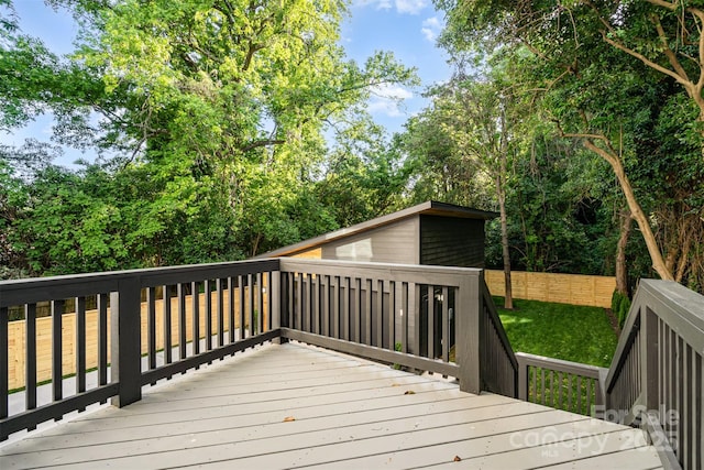 2224 Highland St, Charlotte, NC 28208 - wooden deck featuring an outbuilding and a lawn