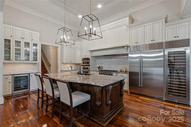 kitchen featuring beverage cooler, crown molding, recessed lighting, backsplash, and dark wood-type flooring