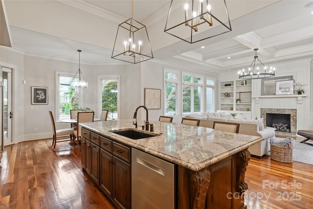kitchen with a sink, a chandelier, dark wood-style floors, stainless steel dishwasher, and crown molding